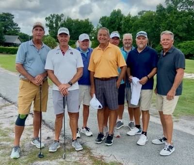 Mark golfing with a group