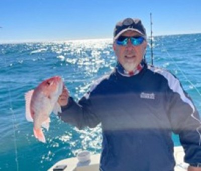 Mark holding up a fish he caught