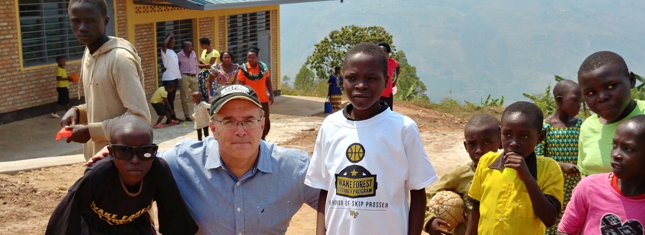 Mark with children at a new school in Rwanda